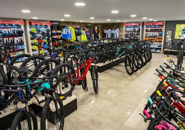 The accessories aisle at The Bike Cellar, lights, bottles, tools and Cyclescheme paperwork on the racks.